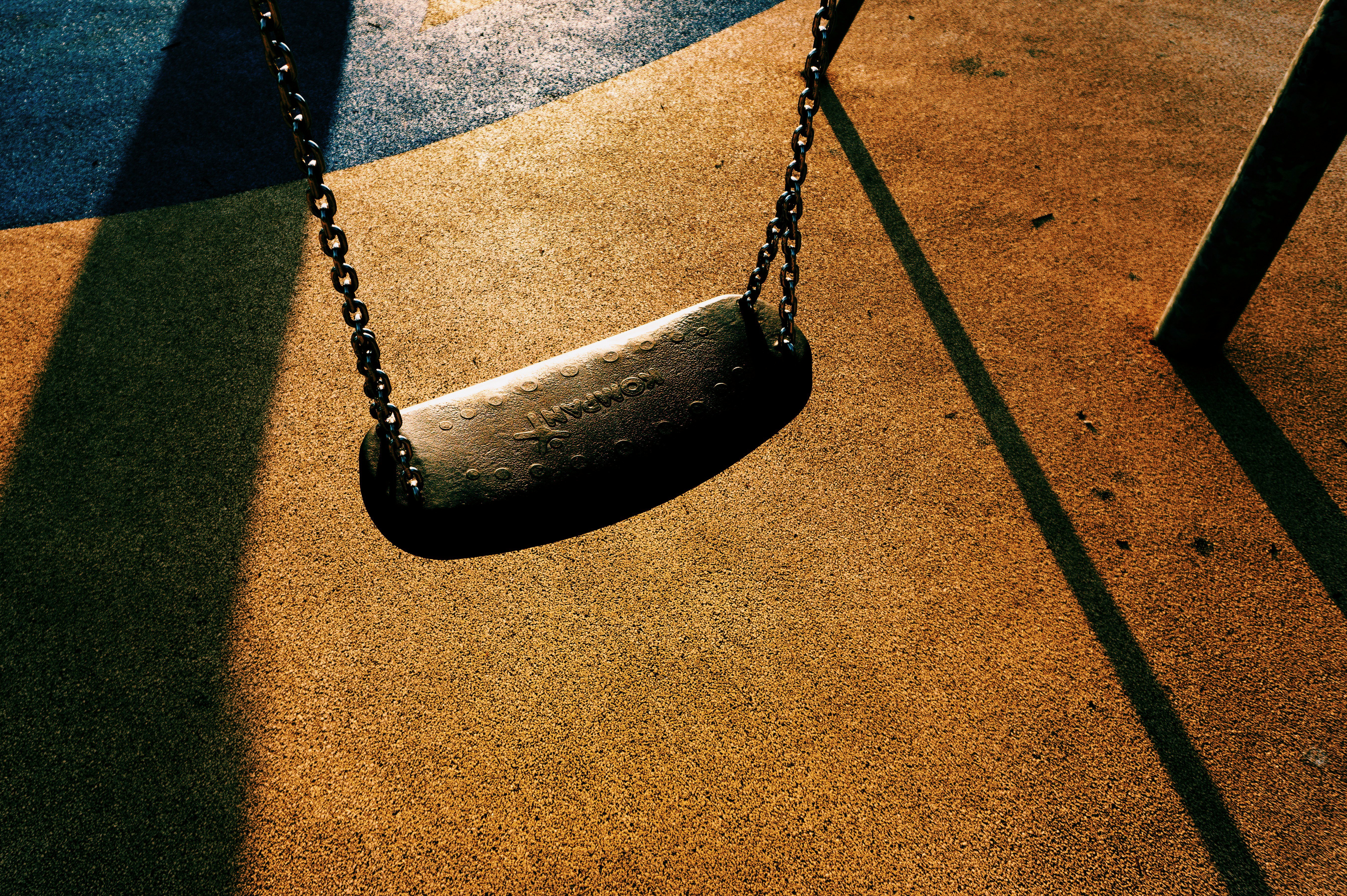 black metal swing on brown concrete floor